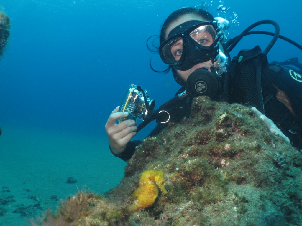 Corinne scuba diving with a seahorse in Lanzarote